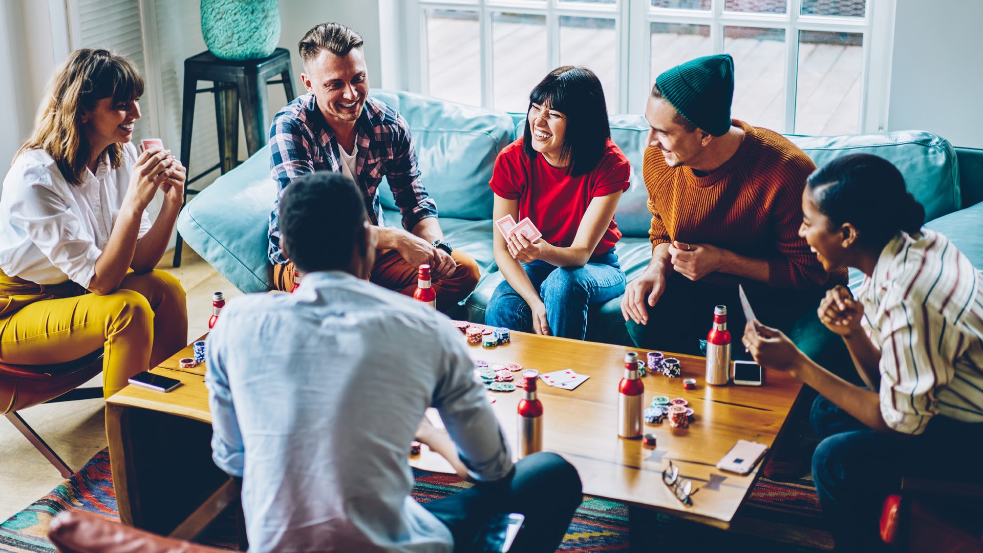 Friends playing a board game together around a table