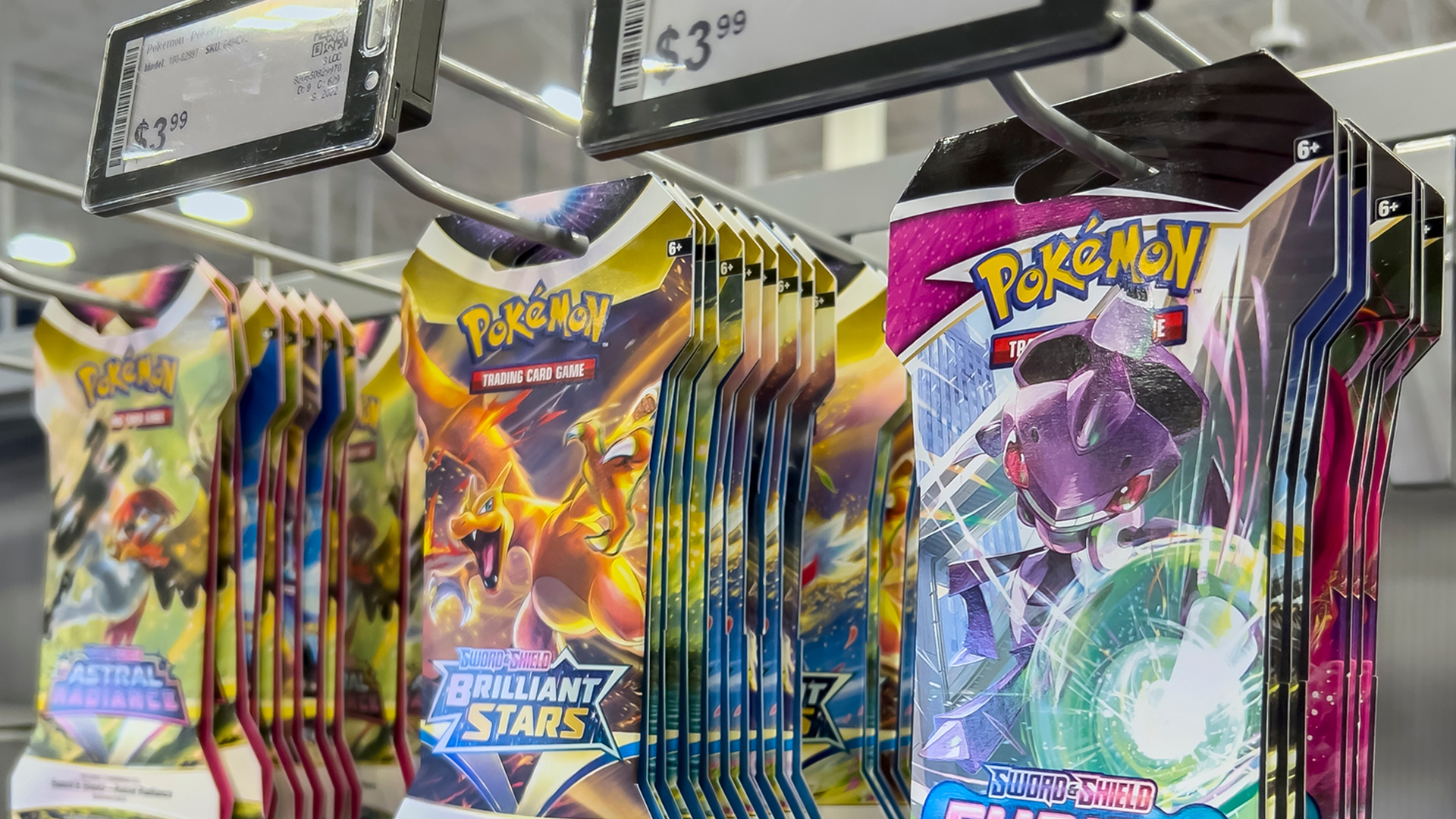 Pokemon cards hanging in a Best Buy store shelf