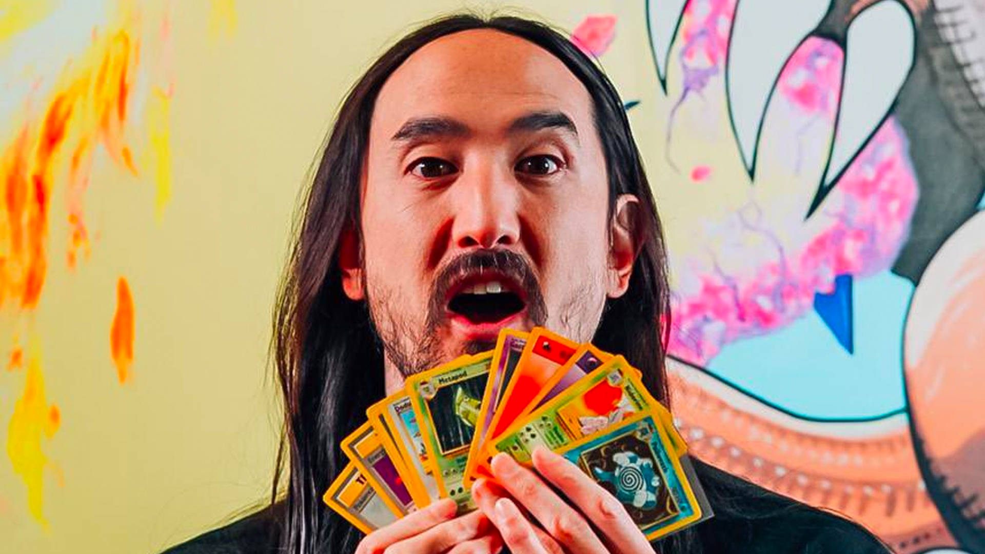 Steve Aoki holding Pokemon cards